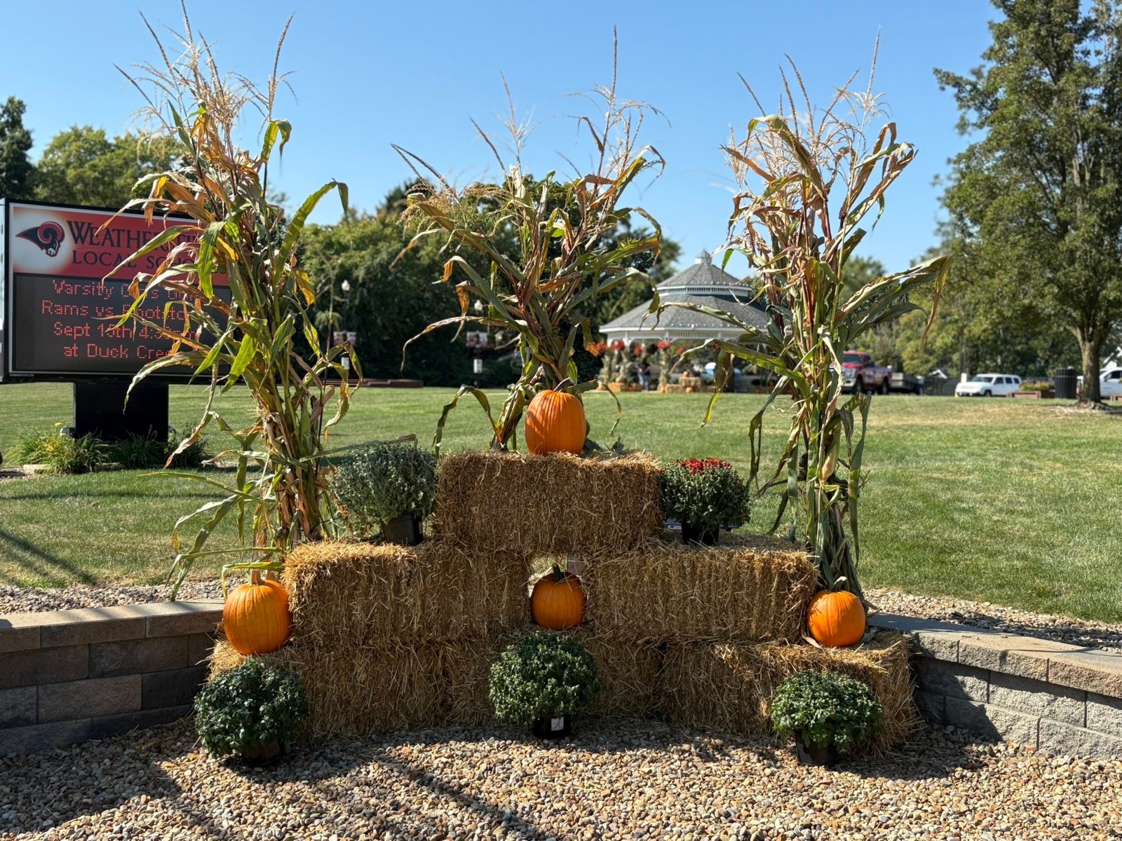 Fall decorations at Weathersfield Community Park — hay bales, pumpkins, and corn stalks by the gazebo